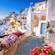 Flowers line a small street leading to homes above the ocean